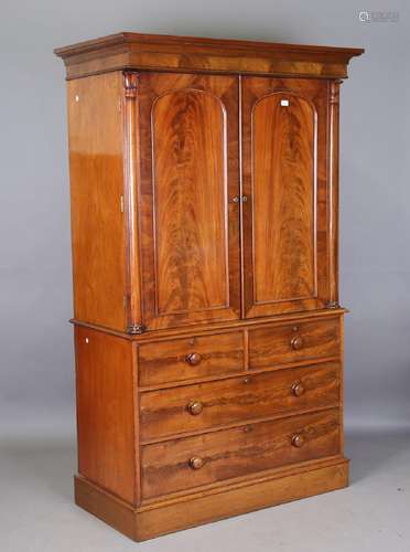 An early Victorian figured mahogany linen press, the two arc...