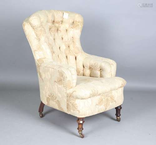 A late Victorian armchair, the substantial buttoned back and...