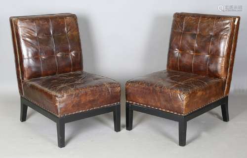 A pair of modern buttoned brown leather easy chairs with bra...