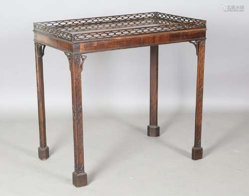 A 19th century mahogany silver table with overall blind fret...