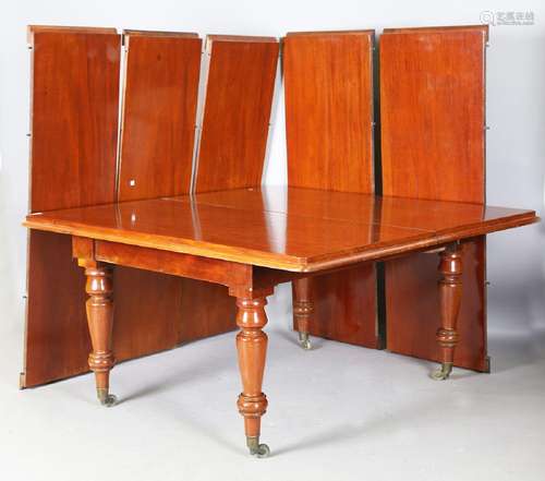 A large Victorian mahogany dining table, the moulded edge to...