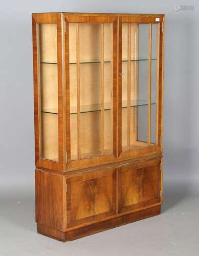 An early 20th century walnut display cabinet by Heals, the i...