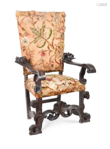 AN ITALIAN CARVED WALNUT AND CREWEL WORK UPHOLSTERED ARMCHAI...