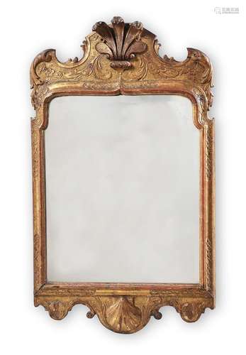 A GEORGE I CARVED GILTWOOD AND GESSO WALL MIRROR, IN THE MAN...