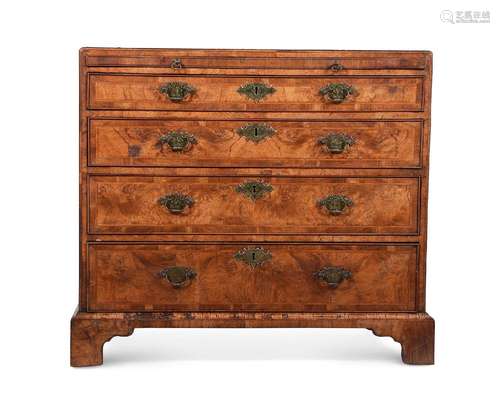 A BURR WALNUT AND FEATHERBANDED CHEST OF DRAWERS IN THE MANN...