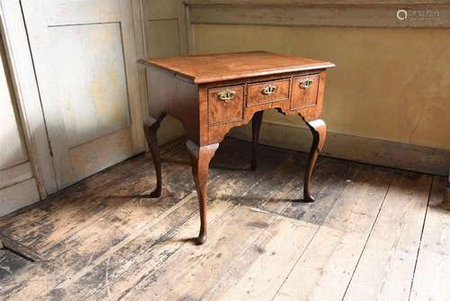 A GEORGE II WALNUT AND FEATHER BANDED SIDE TABLE, CIRCA 1730