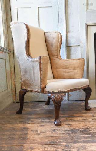 A GEORGE II CARVED WALNUT WING ARMCHAIR, CIRCA 1740