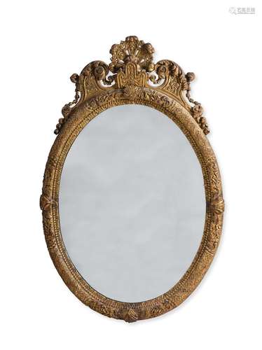 A QUEEN ANNE  CARVED GILTWOOD OVAL MIRROR, IN THE MANNER OF ...