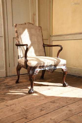 A GEORGE II CARVED WALNUT OPEN ARMCHAIR, ATTRIBUTED TO JAMES...