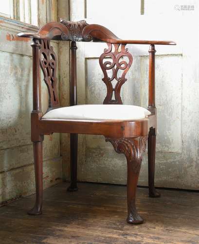 A GEORGE II CARVED MAHOGANY CORNER OR READING ARMCHAIR, CIRC...