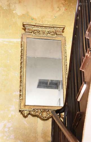 A GEORGE II CARVED GILTWOOD MIRROR, IN THE MANNER OF WILLIAM...