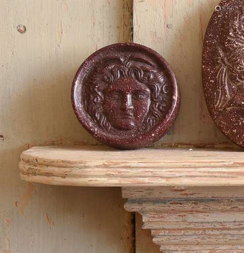 A CARVED RED PORPHRITIC STONE CAMEO OF THE MEDUSA RONDANINI,...