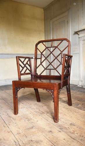 A GEORGE III MAHOGANY 'COCKPEN' ARMCHAIR, IN THE MANNER OF T...