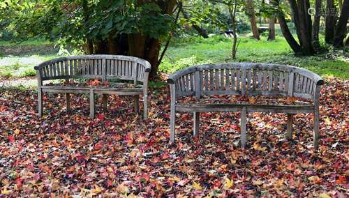 A PAIR OF HARDWOOD GARDEN BENCHES OF 'BANANA' FORM, MODERN