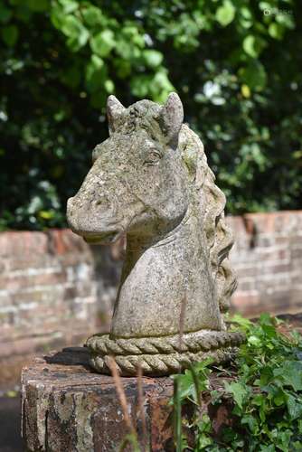 A SET OF FOUR COMPOSITION STONE HORSE HEAD FINIALS, 20TH CEN...