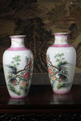 A pair of pastel flower and bird pattern bottles