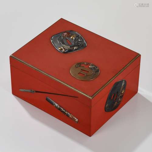 A SUPERB RED LACQUER TEBAKO WITH SIMULATED-METAL SWORD FITTI...