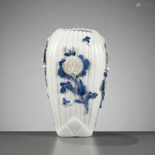 A MOLDED AND CARVED HIRADO BLUE AND WHITE VASE WITH CHRYSANT...