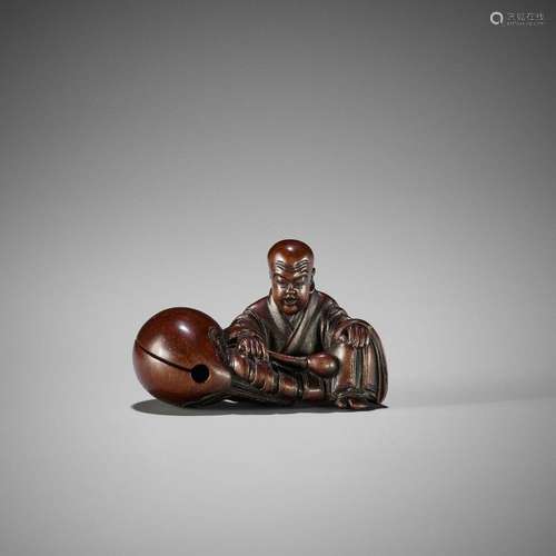 SHURAKU: A FINE WOOD NETSUKE OF A MONK WITH MOKUGYO