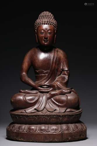 In the Qing Dynasty, mahogany Shakya Buddha sits in a pose