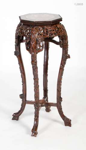 A Chinese carved darkwood stand, Qing Dynasty, the octagonal...