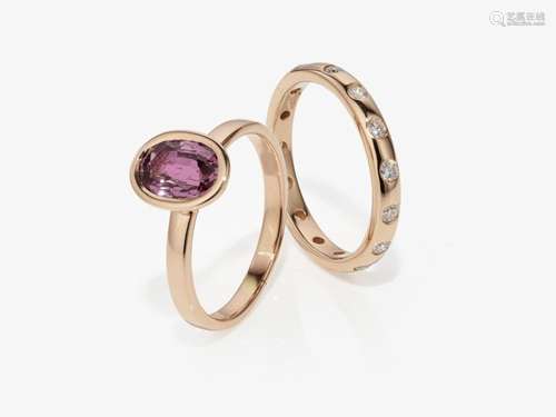 A pink intense sapphire ring with a band ring decorated with...