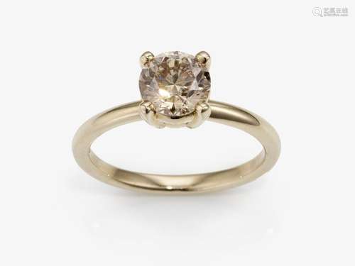 A solitaire ring with a brilliant-cut diamond in a natural f...