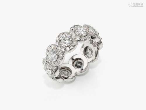 An expressive entourage-set eternity ring decorated with bri...