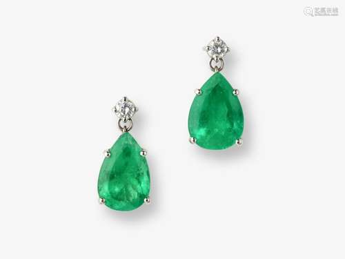 A pair of stud earrings decorated with Colombian emeralds an...