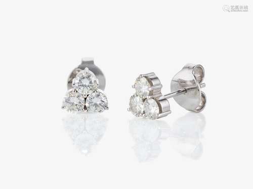 A pair of triangle-shaped stud earrings decorated with brill...