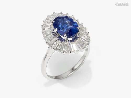 An entourage ring decorated with a fine sapphire and trapeze...