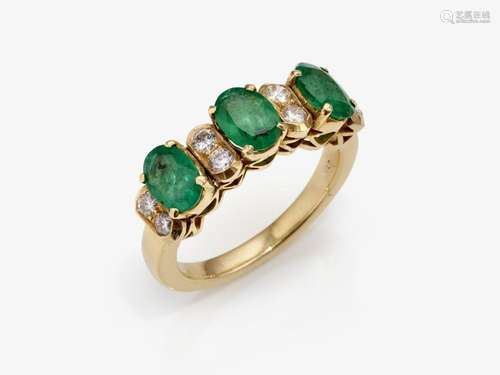 An eternity ring decorated with emeralds and brilliant-cut d...