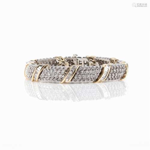 A fourteen karat white and yellow gold and shared prong-set ...