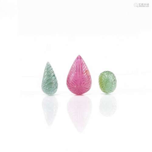 Three carved pink and green tourmaline loose gems