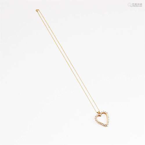 A fourteen karat gold and diamond heart pendant necklace