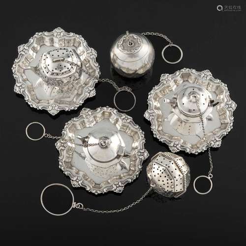 A collection of sterling silver tea balls and coasters