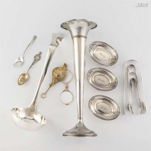 A collection of sterling silver utensils and dishes