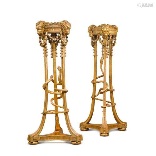 A pair of George III carved giltwood torcheres by Mayhew and...