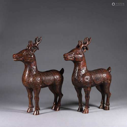 A pair of copper deer ornaments