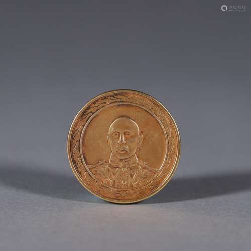 A figure patterned gold coin