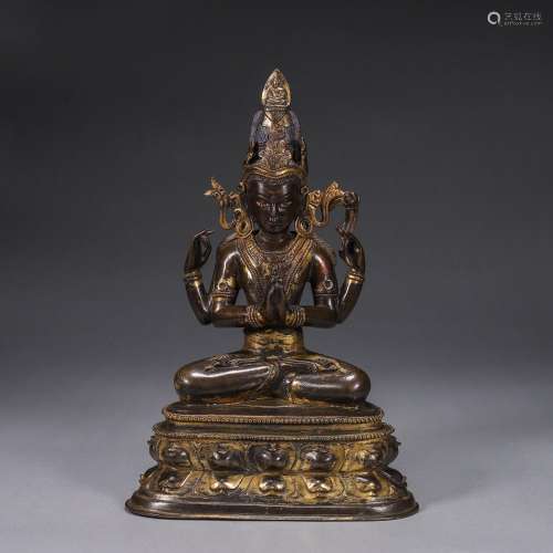 A gilding copper four-armed buddha statue