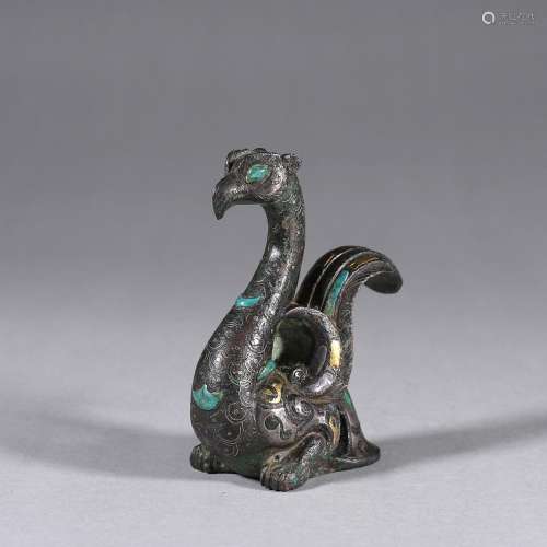 A turquoise-inlaid bronze bird ornament