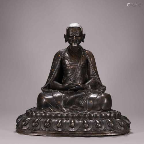 A silver-inlaid copper buddha statue