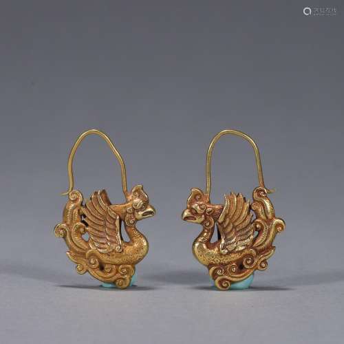 A pair of gold phoenix bird earrings