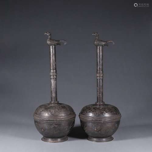 A pair of silver phoenix pots
