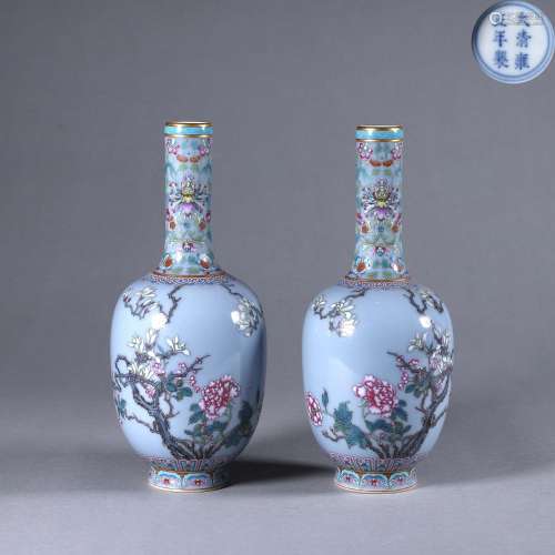 A pair of blue ground famille rose flower porcelain vases