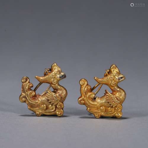 A pair of gold phoenix bird earrings
