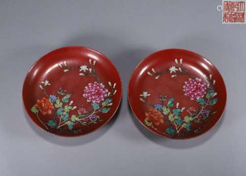 A pair of red ground famille rose peony porcelain plates