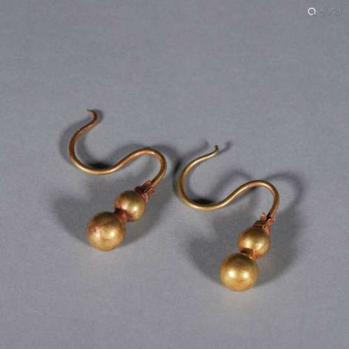 A pair of gourd shaped gold earrings