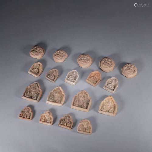 A group of clay buddha models